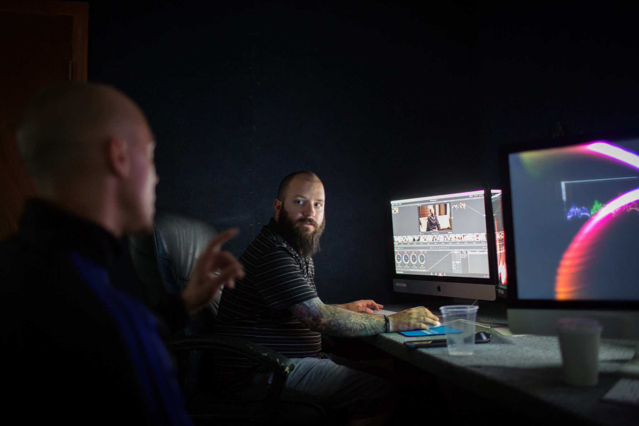 Instructor teaching student advanced color grading techniques in DaVinci Resolve