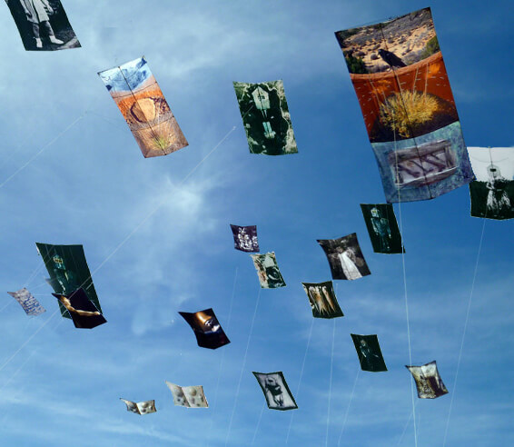 Multiple works of art flying as kites in the air