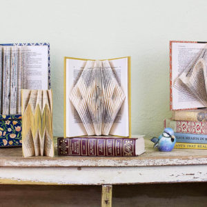 3 unique examples of recycled book arts design on a table