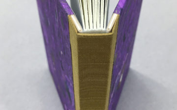 Open book showing a beautifully made sewn board binding