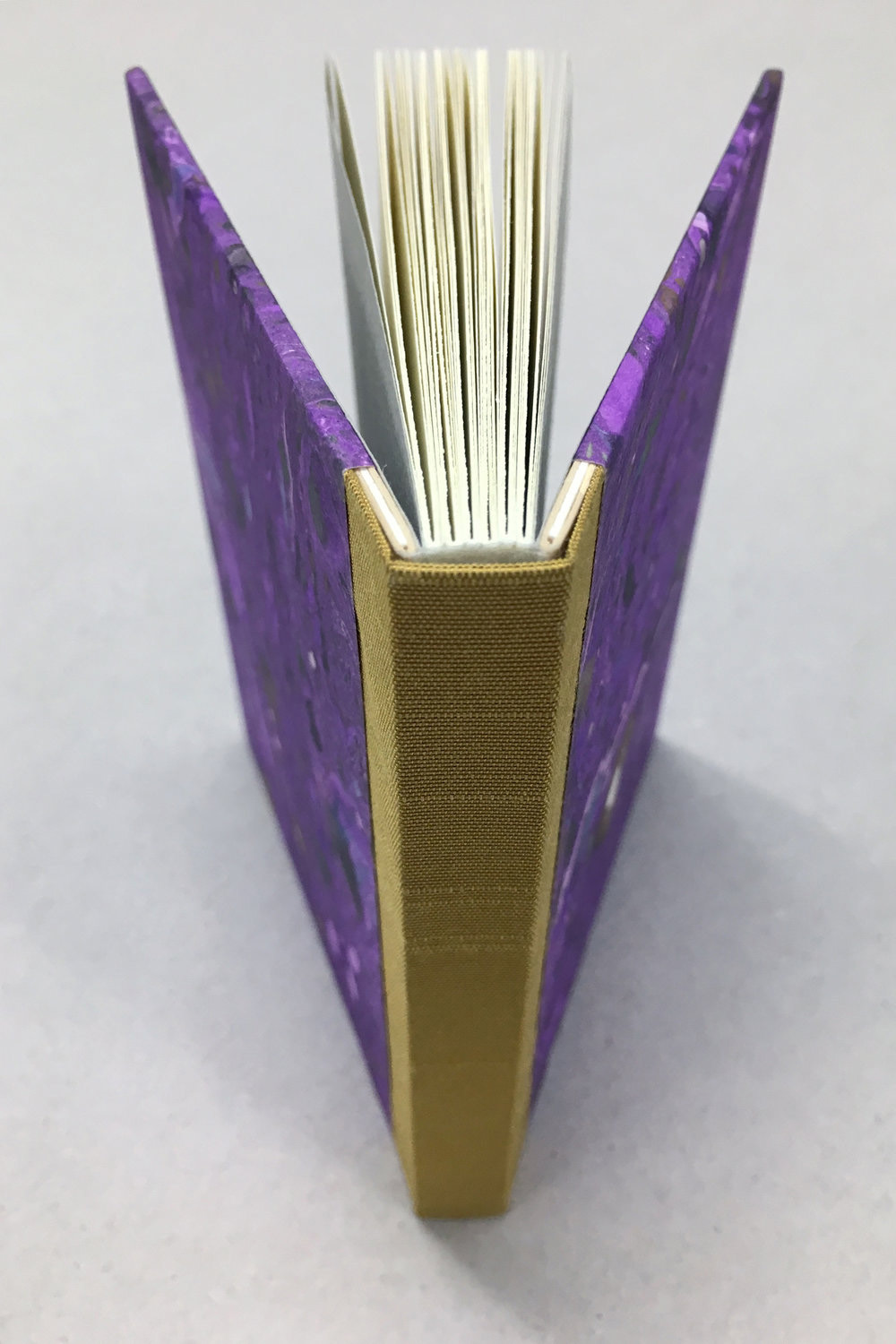 Open book showing a beautifully made sewn board binding