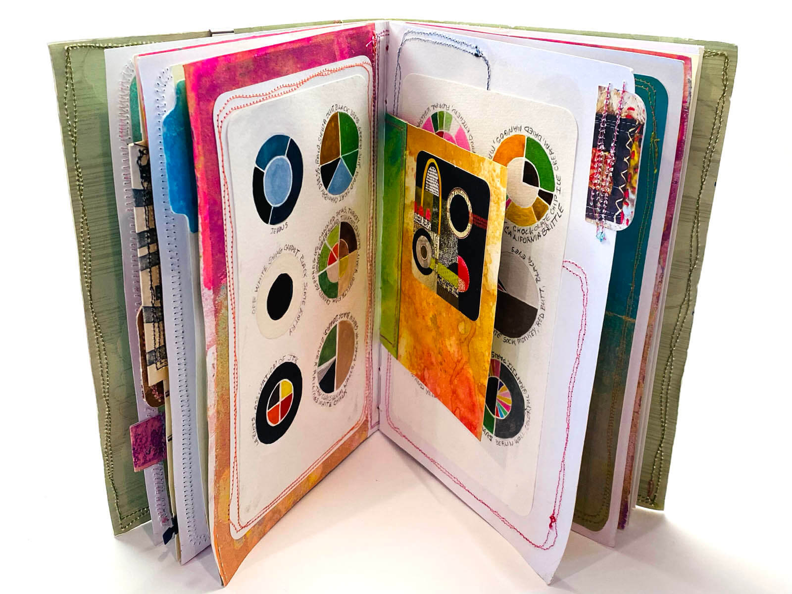Design Extravaganza book, with the book open and colorful images on the pages - By Marsha Shaw