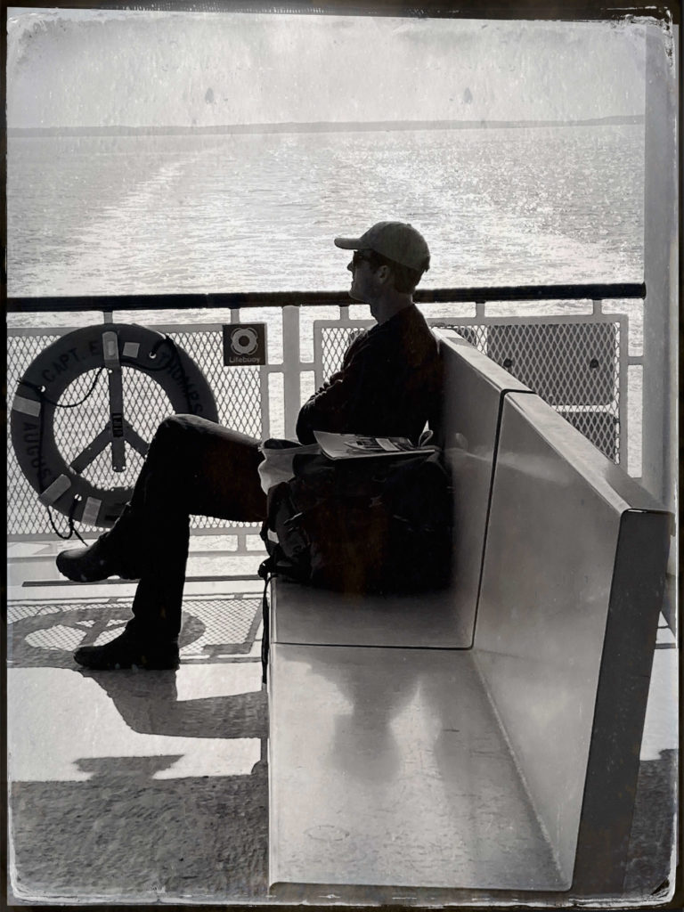 Person sitting on the ferry as it moves along