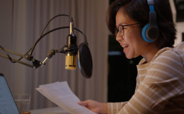 Woman talking into a microphone during a podcast
