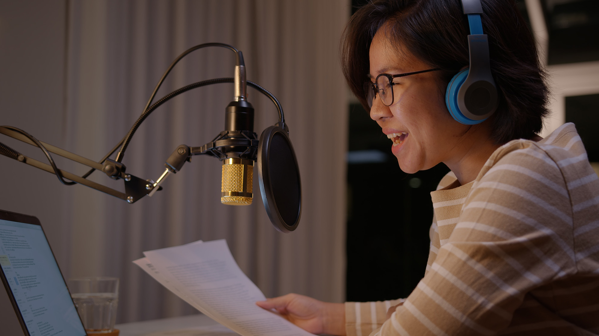 Woman talking into a microphone during a podcast